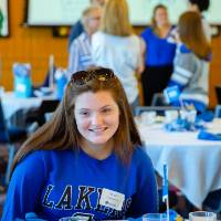 A student enjoying conversation at the table at the Laker Legacy Brunch